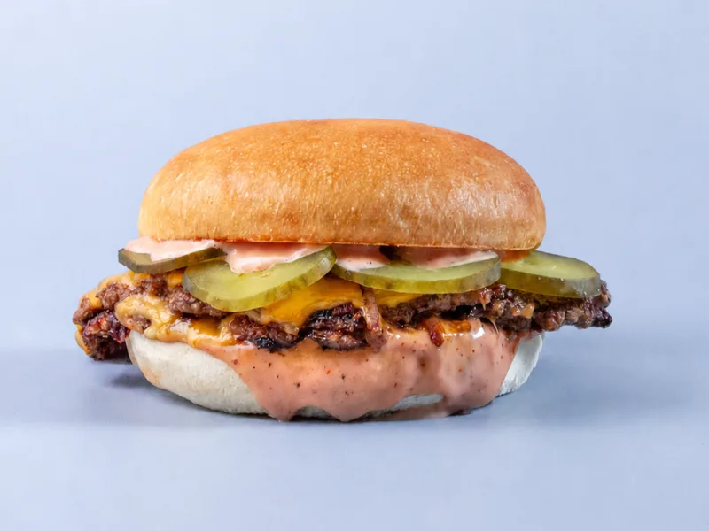 All-Out smash burger with cheese, pickles and sauce